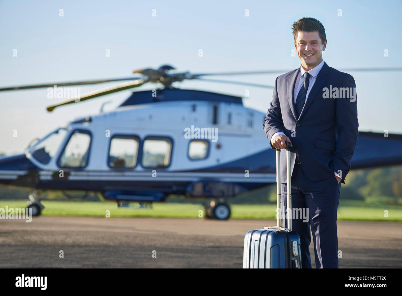 Portrait Of businessman standing in front of Helicopter Banque D'Images