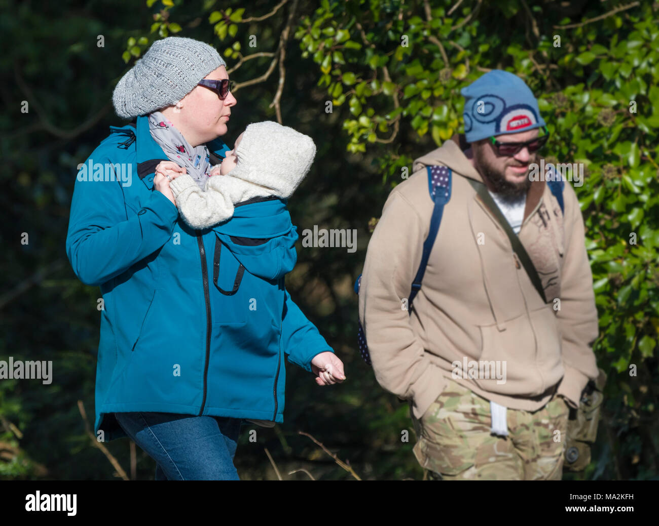 Un Couple En Train De Marcher En Hiver Avec La Femme Portant Un Bebe Dans Un Support Fixe Sur Son Front Garder Le Bebe Fermer Photo Stock Alamy