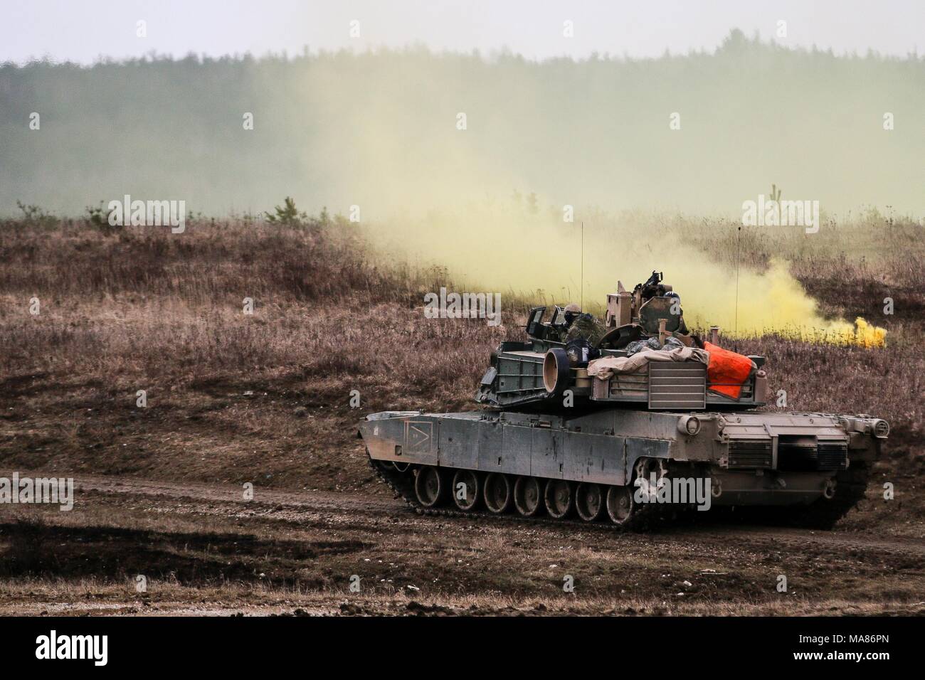 Un M1 Abrams tank, à partir du 5e Escadron, 4e régiment de cavalerie blindée, 2e Brigade Combat Team, 1re Division d'infanterie, utilise une grenade fumigène pour sécuriser une zone au cours d'un exercice de tir réel interarmes (CALFEX) à Grafenwoehr Domaine de formation, l'Allemagne, Mai 28, 2018. (U.S. Photo de l'armée par la CPS. Hubert D. Delany III / 22e Détachement des affaires publiques mobiles) Banque D'Images