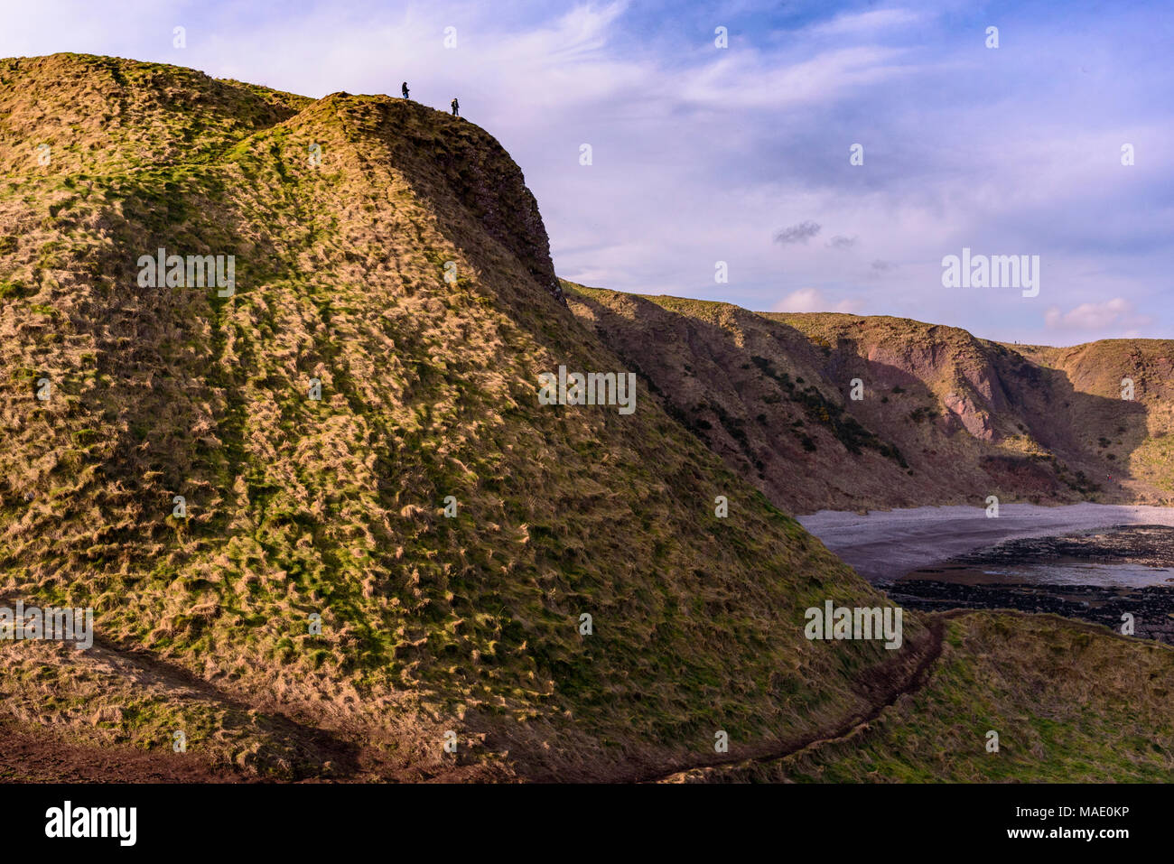 Les marcheurs sur le dessus de la colline sur la plage. Banque D'Images