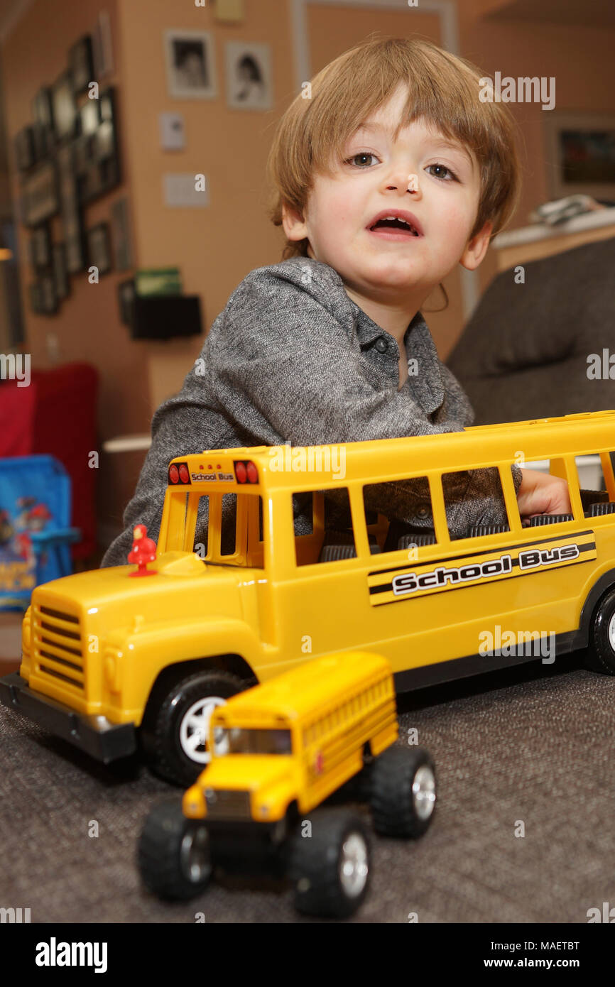 Montréal,Canada,31,mars,2018.jeune garçon de 3 ans à l'intérieur avec un jouet school bus.Credit:Mario Beauregard/Alamy Live News Banque D'Images