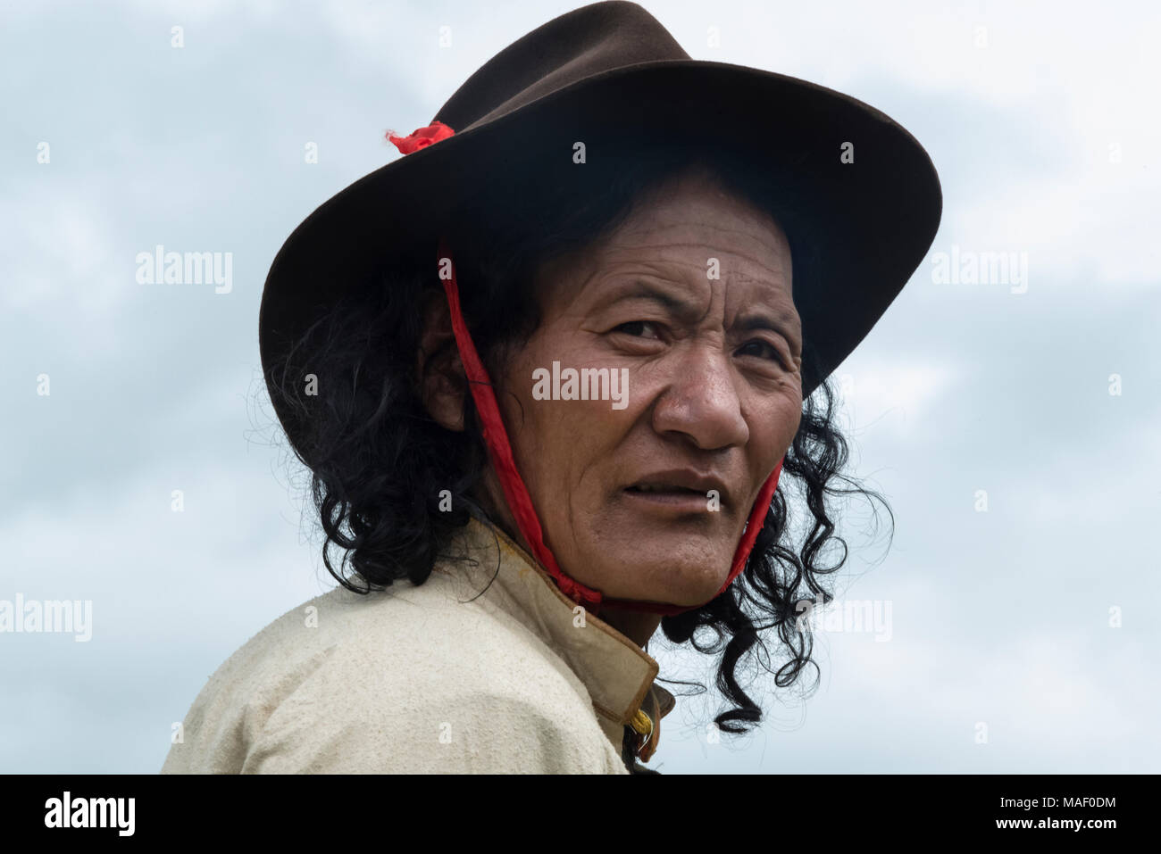 L'homme en costume traditionnel tibétain à Horse Race Festival, Litang, l'ouest du Sichuan, Chine Banque D'Images