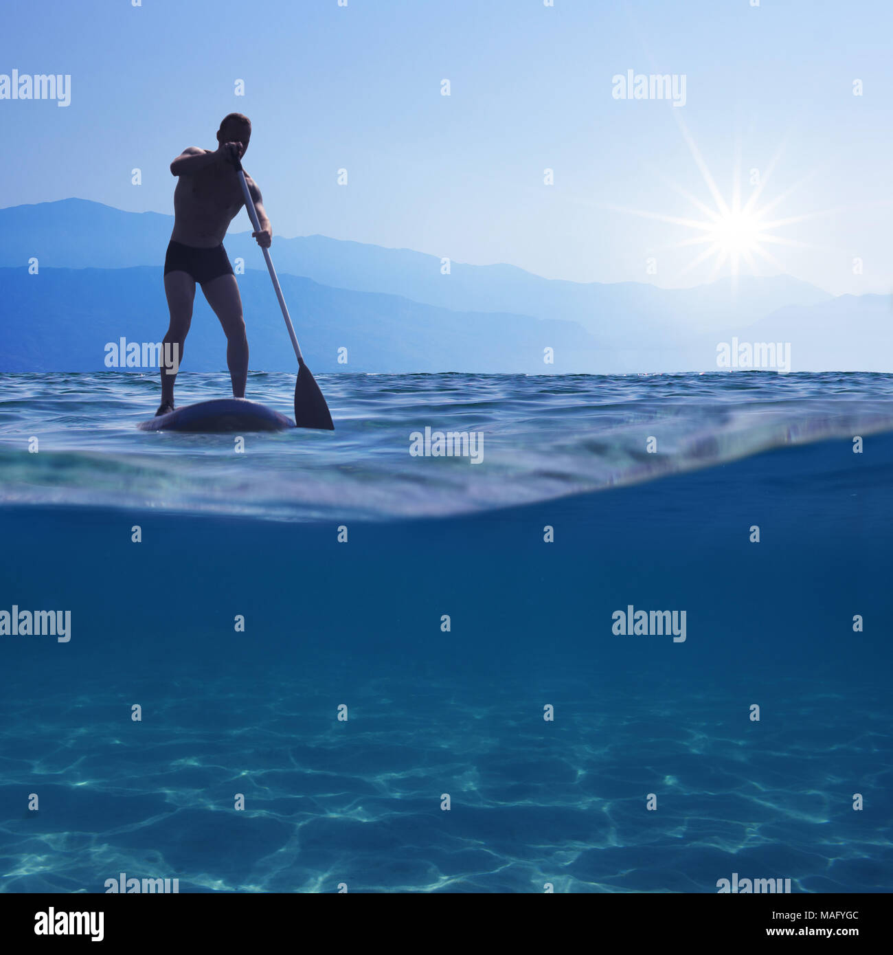 Stand Up Paddle. Jeune homme flottant sur un bord sup. Sous-vue de mer, l'espace de copie pour le texte Banque D'Images