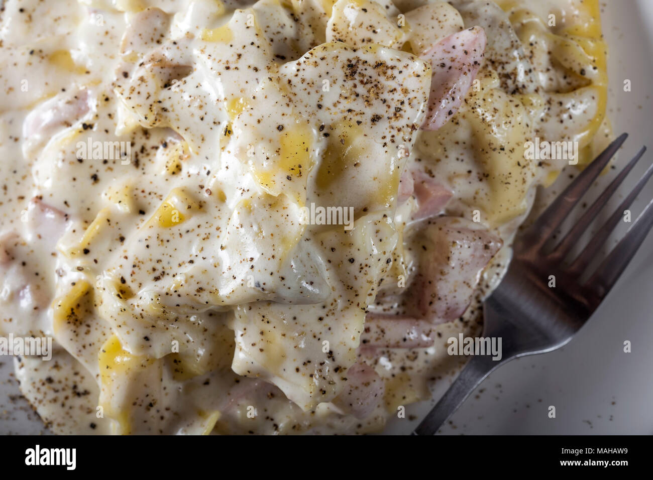 Tortellini et ravioli au jambon fumé et les champignons et sauce à la crème aigre Banque D'Images