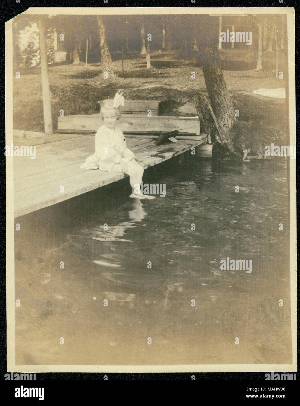 Titre : Mildred Frances Lyon se balançant ses pieds dans le lac à la résidence d'été. . Vers 1905. Banque D'Images