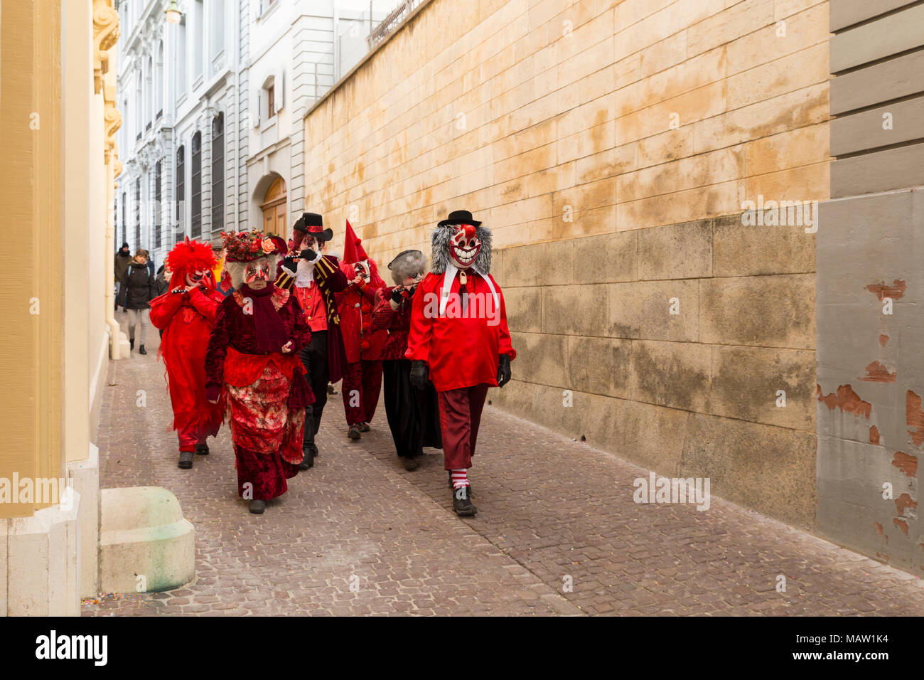 Carnaval de Bâle. Rheinsprung, Bâle, Suisse - 21 février 2018. Groupe de fêtards s'en rouge costumes dans la vieille ville Banque D'Images