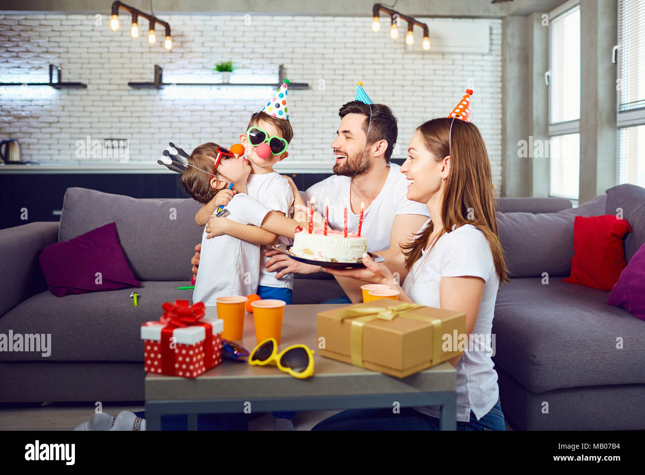 Une famille heureuse avec un gâteau célèbre un anniversaire. Banque D'Images