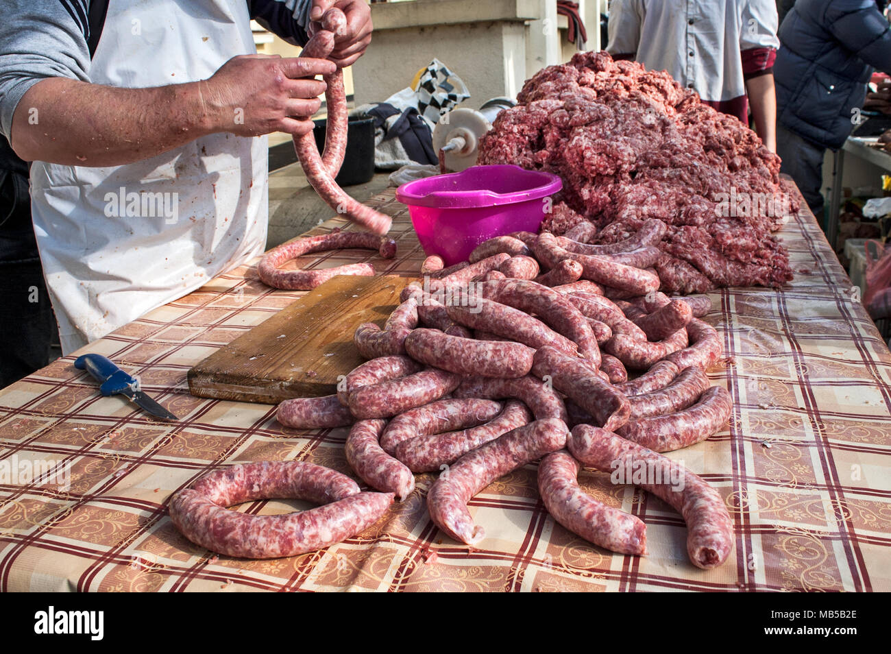 Le Boucher fait des saucisses en plein air de façon traditionnelle. Banque D'Images
