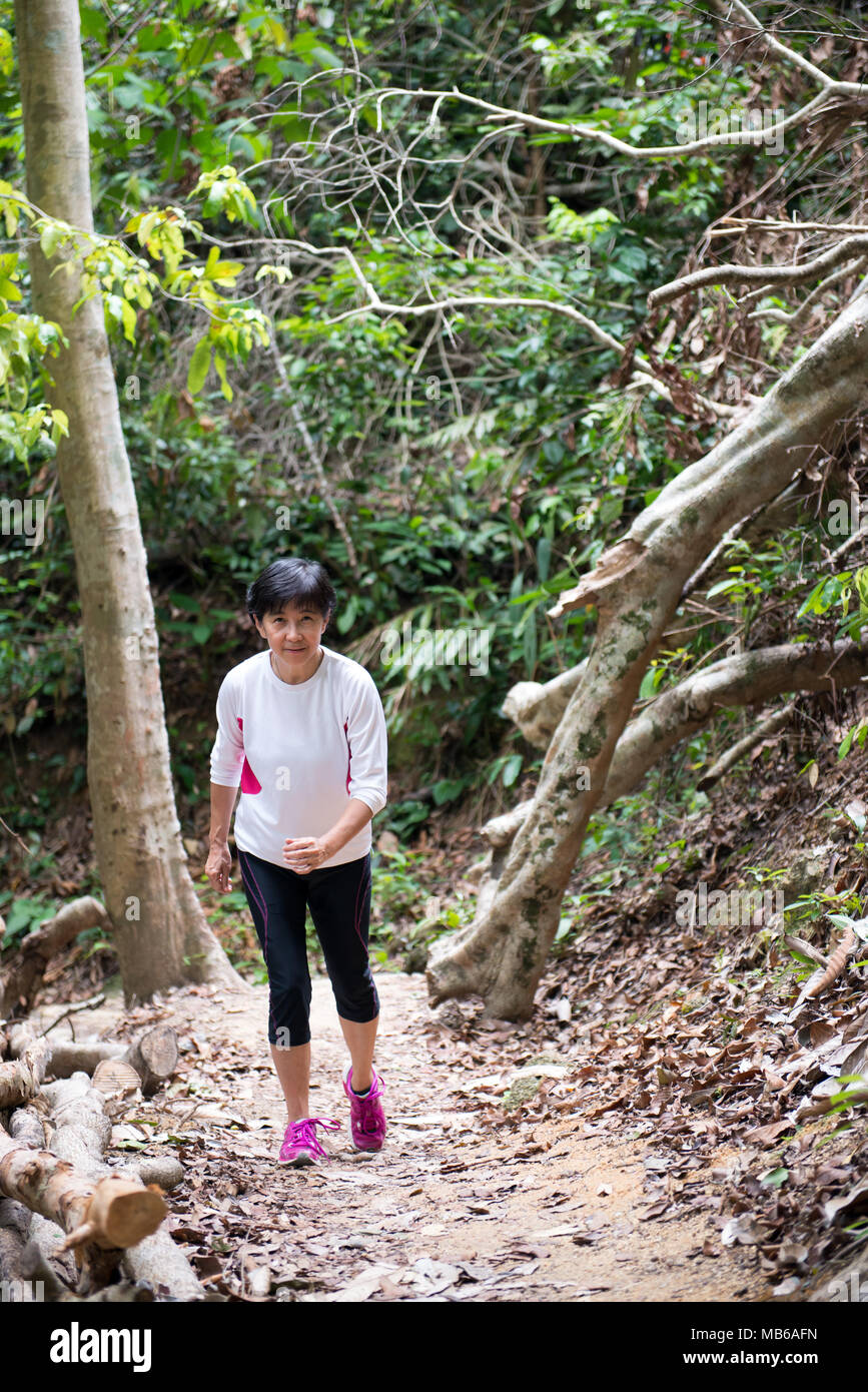 Asian woman hiking in jungle Photo Stock - Alamy