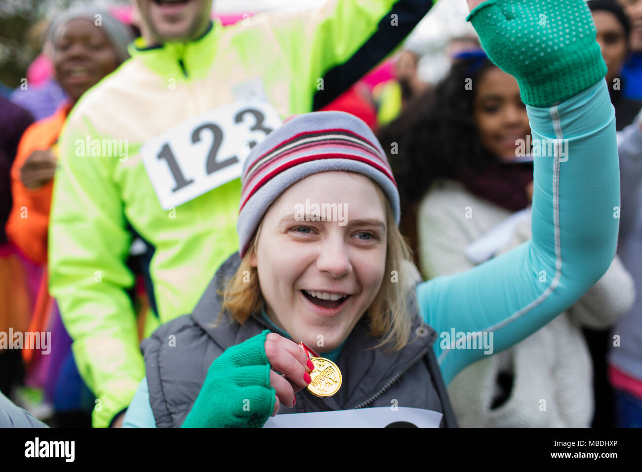 Femme enthousiaste avec leur équipe de course de bienfaisance médaille Banque D'Images