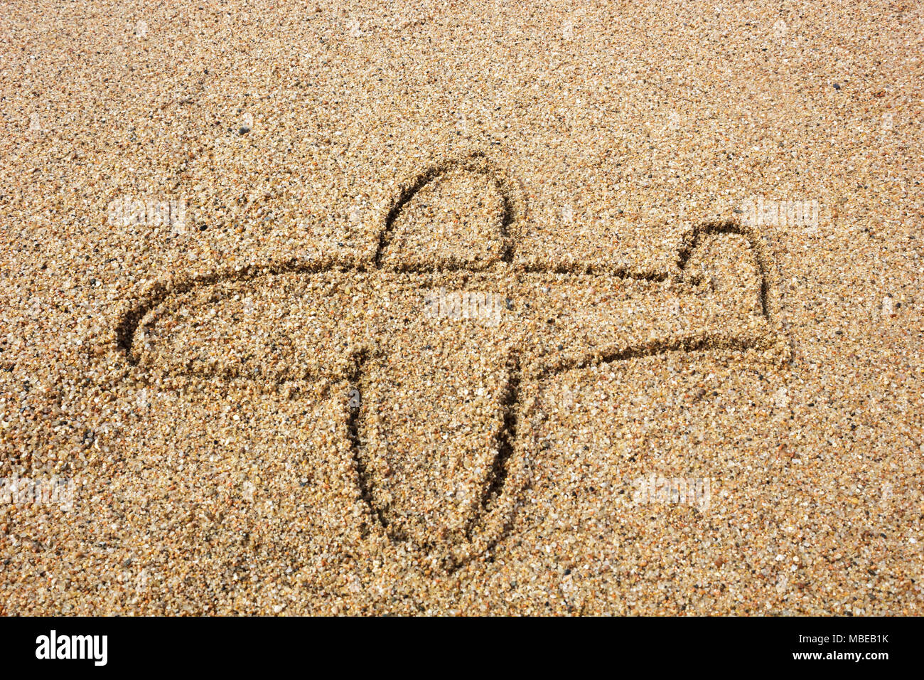 Silhouette d'avion dans le sable Banque D'Images