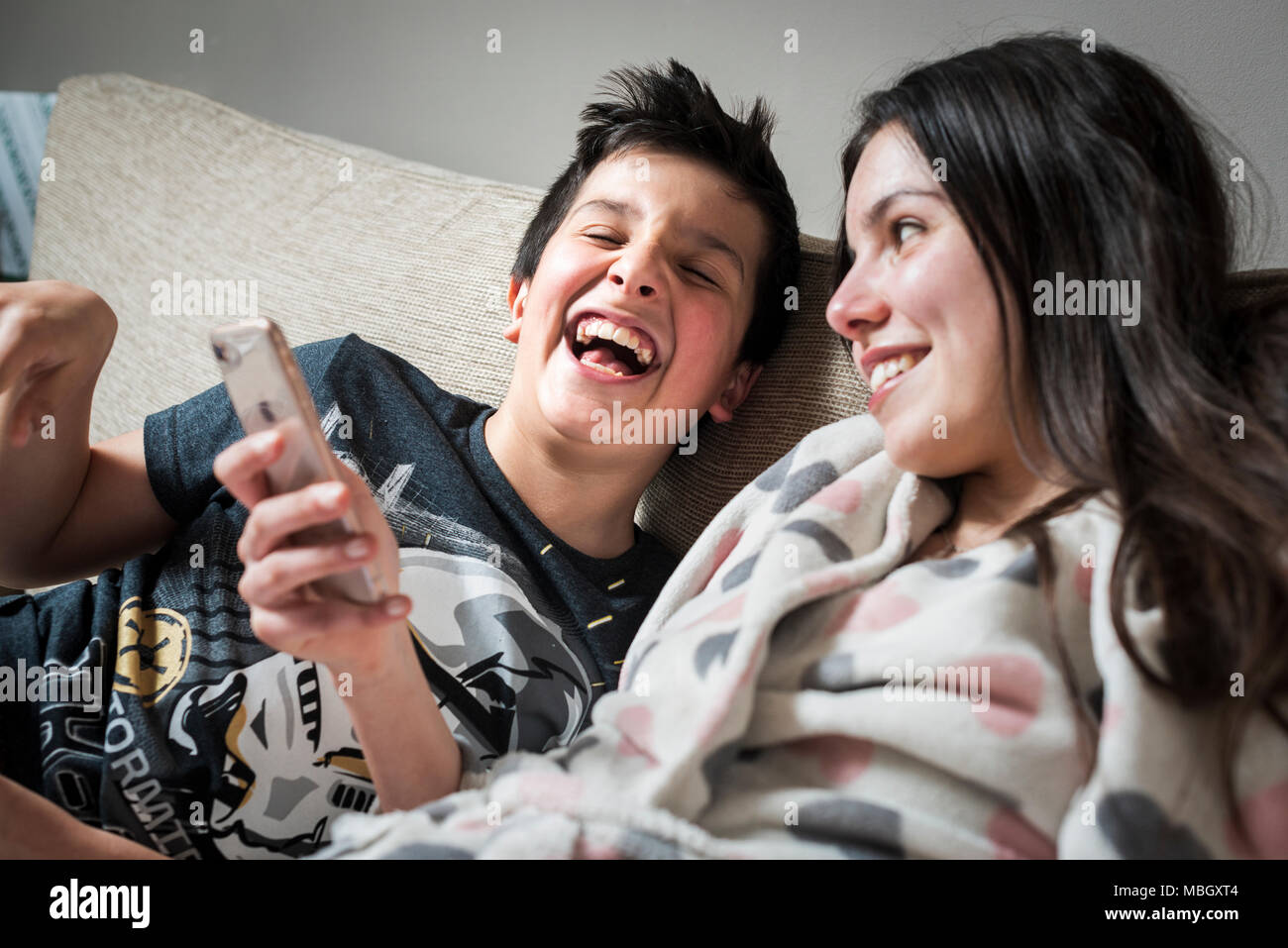 Les enfants de regarder des vidéos drôles ensemble sur smart phone Banque D'Images