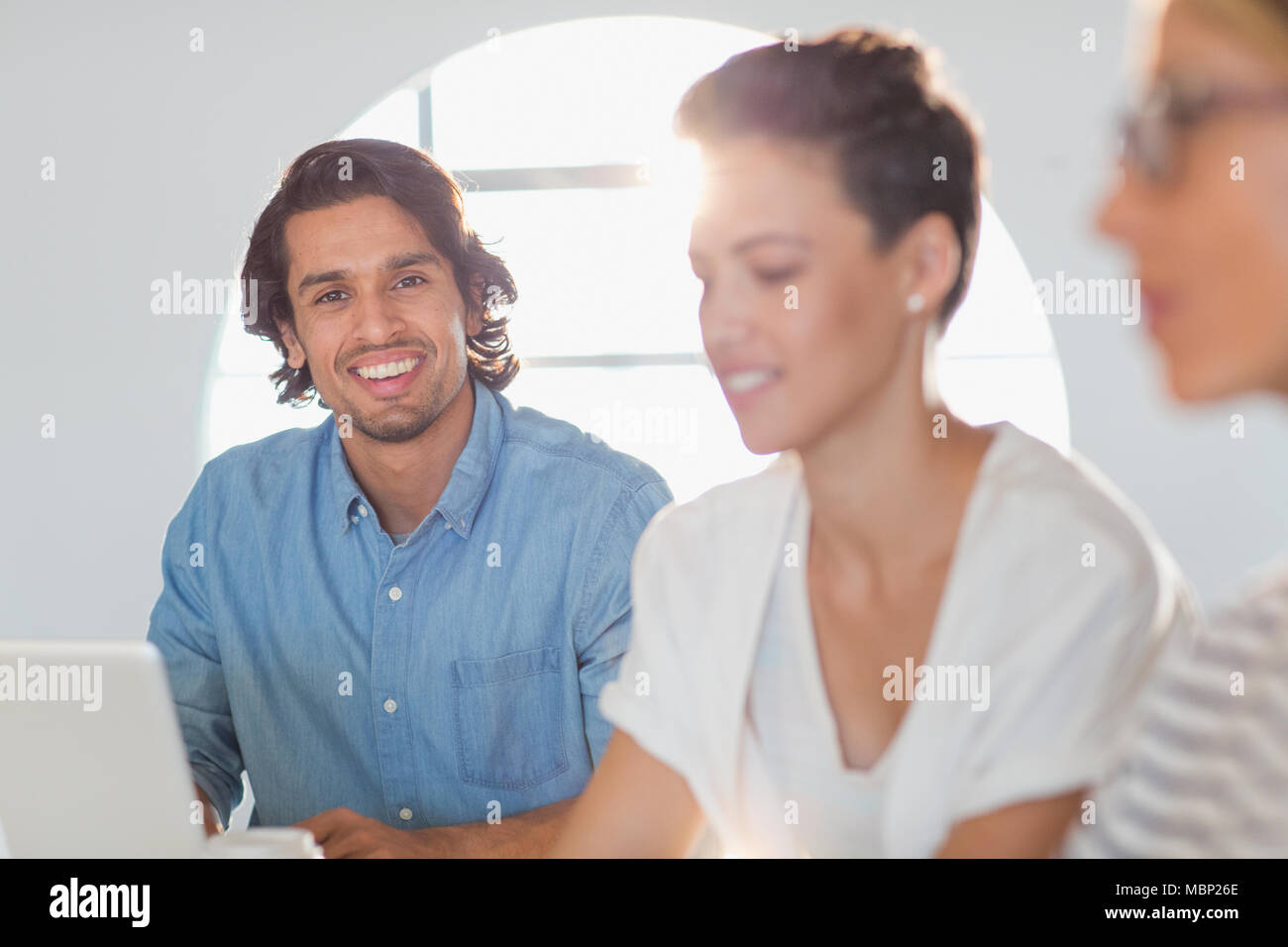 Portrait of smiling, confident businessman in meeting Banque D'Images