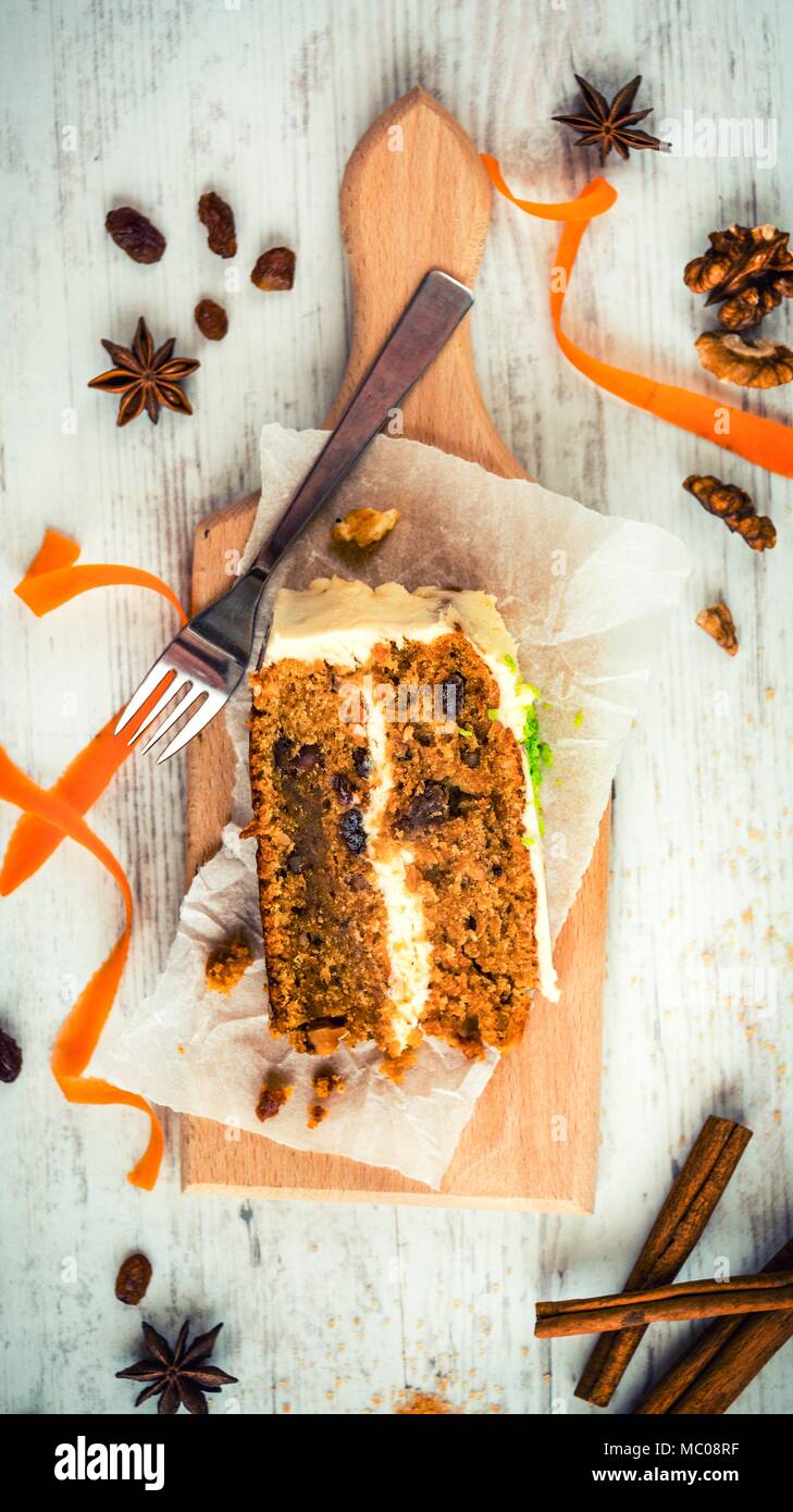 Vue de dessus d'un gâteau aux carottes et aux raisins secs, noix et cannelle over white background. De fromage fondu. Banque D'Images