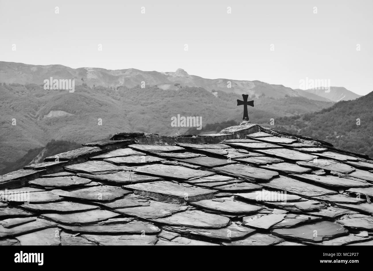 Croix orthodoxe sur le toit d'une petite église en Macédoine en noir et blanc Banque D'Images