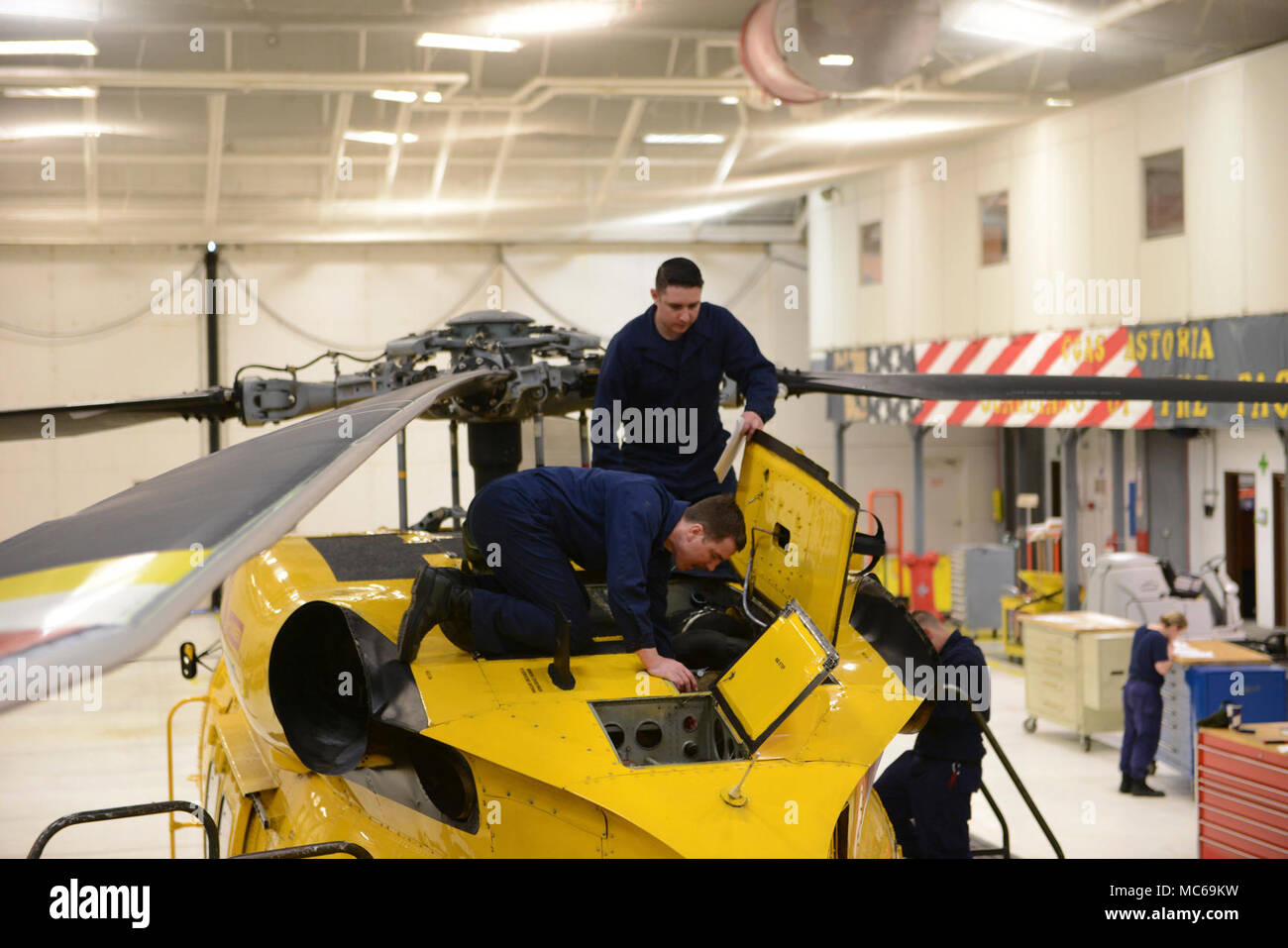 Maître de 3e classe Kyle et Jack Gould Earl, les deux techniciens de maintenance de l'aviation du secteur au fleuve Columbia, travailler sur un hélicoptère Jayhawk MH-60 à l'intérieur d'un hangar de la base du secteur dans la région de Warrenton, Oregon, le 19 mars 2018. Les fonctions principales d'un AMT sont l'inspection, l'entretien, la maintenance et le dépannage tous les systèmes de l'avion. Banque D'Images