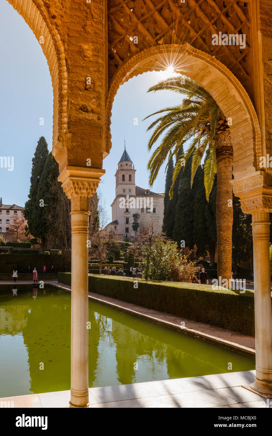 Vue à travers une arcade, église de Santa María de la Alhambra, El Partal avec piscine et palmiers, à l'Alhambra Banque D'Images