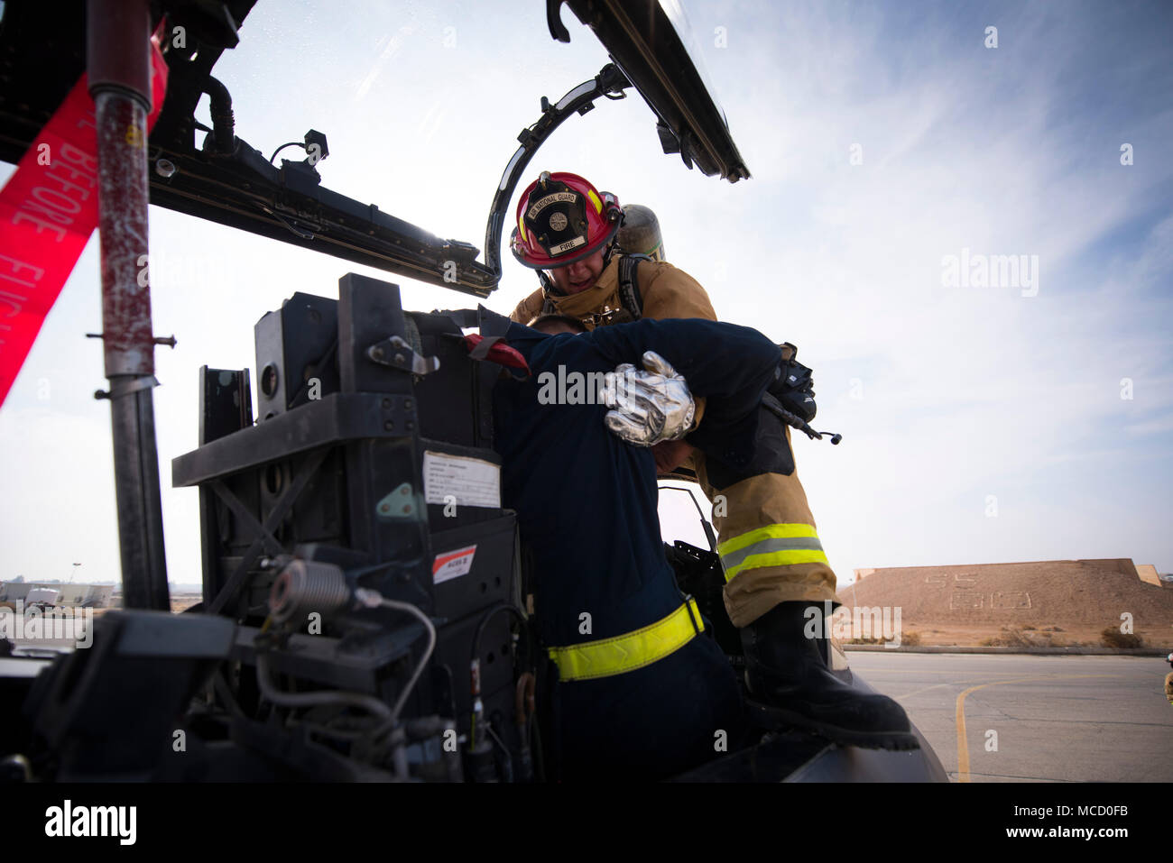 Le Sgt Tech. Kaleb Draper, un pompier affecté au 332e Escadron expéditionnaire d Ingénieur Civil, tire sur une victime simulée depuis le cockpit d'un F-15E Strike Eagle pendant une évacuation d'urgence le 14 février 2018 Formation en Asie du Sud-Ouest. Le scénario prévoyait un pilote qui était devenu inapte, perte de communication avec le contrôle de la circulation aérienne. (U.S. Photo de l'Armée de l'air par le sergent. Joshua Kleinholz) Banque D'Images