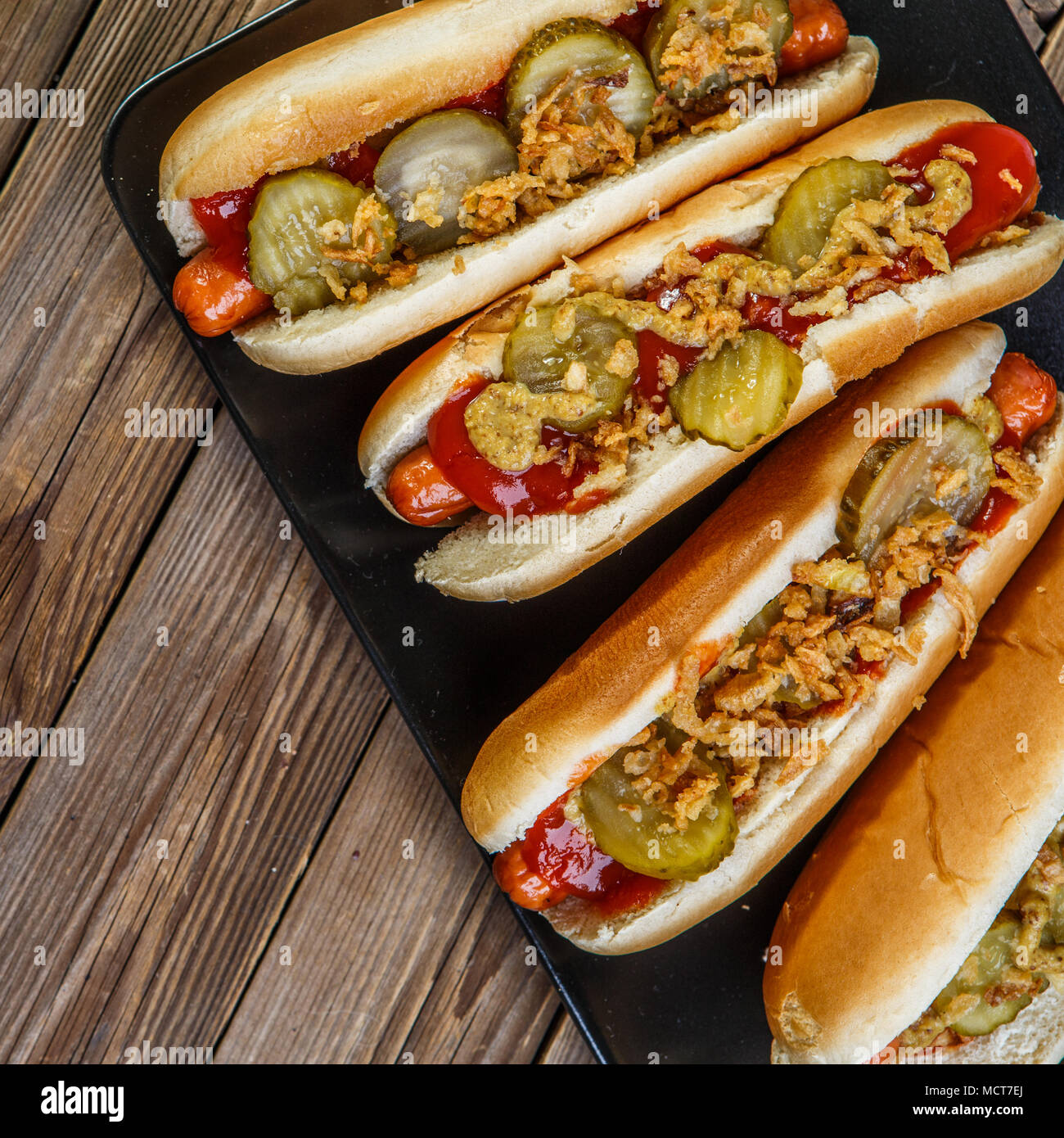 Hot dog américain avec oignons, cornichons, moutarde et ketchup Photo