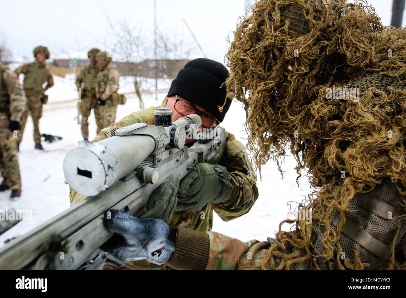 Un tireur au Royaume-Uni avec le 1er Bataillon du Royal Welsh (droite) de l'armée américaine apprend la CPS. Anthony Yang (à gauche), un natif de San Diego, en Californie et une substance chimique, biologique, radiologique, nucléaire et spécialiste à la 82e bataillon du génie de la Brigade Blindée, 2e Brigade Combat Team, 1re Division d'infanterie, les fondamentaux de la L115A3 Fusil à longue portée lors d'une session de formation de multinationales en Tapa, l'Estonie, le 9 mars 2018 dans le cadre d'un exercice de préparation d'intervention rapide à l'appui de la résolution de l'Atlantique. (U.S. Photo de l'armée par la CPS. Hubert D. Delany III/22e Détachement des affaires publiques mobiles) Banque D'Images
