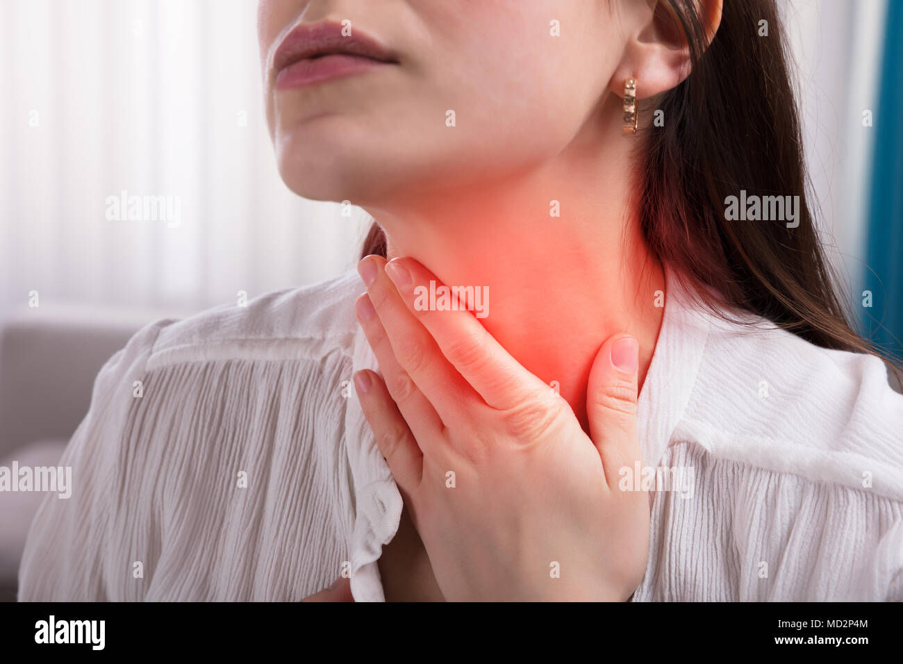 Close-up of a Woman's Hand Touching son mal de gorge Banque D'Images