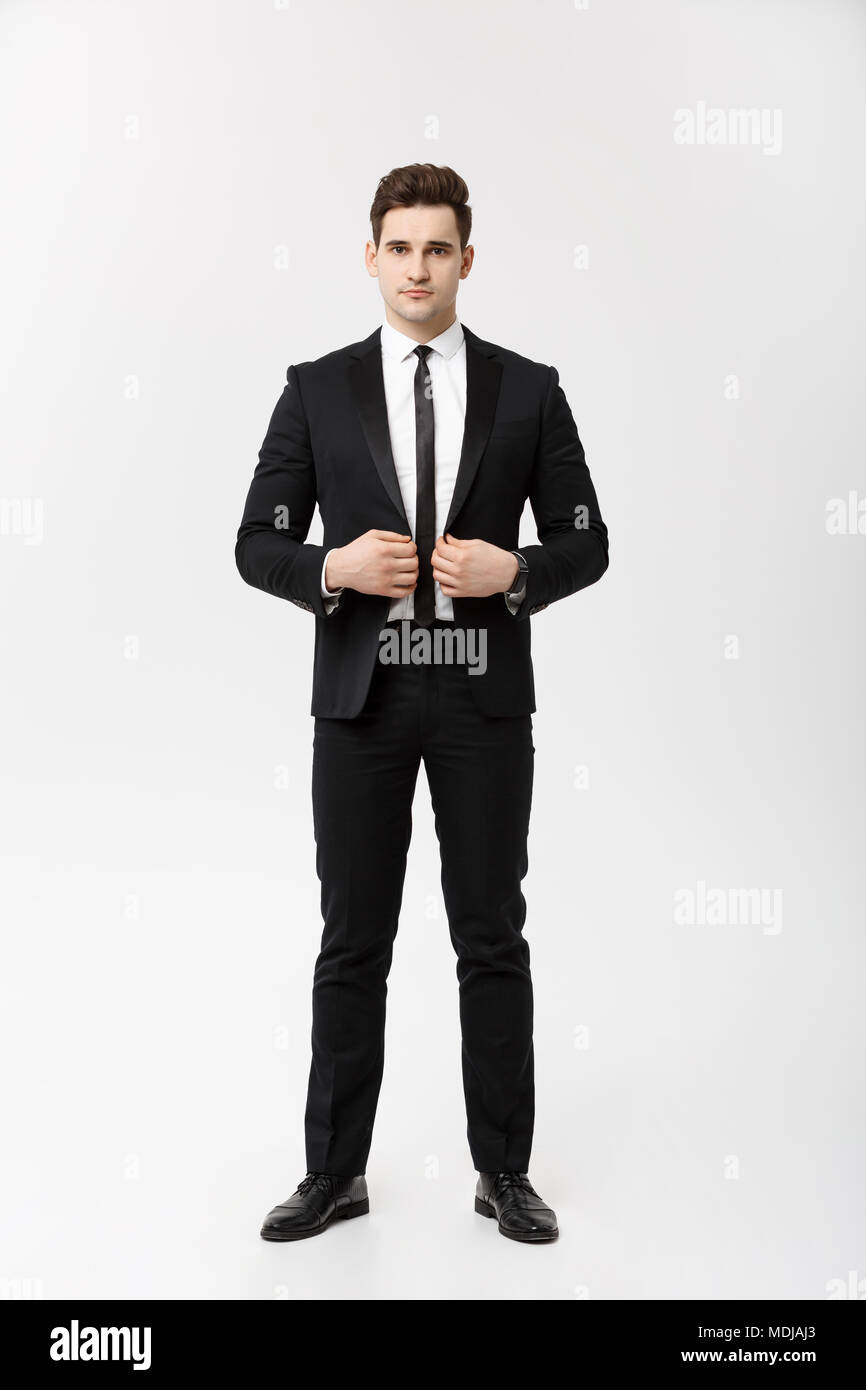 Concept d'entreprise : bel homme sourire heureux jeune beau mec en costume  smart posant sur fond gris isolé Photo Stock - Alamy