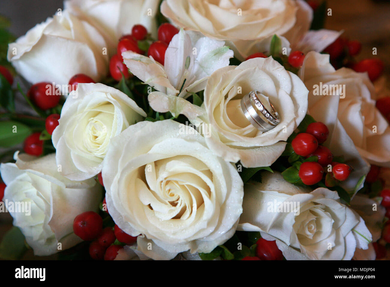 Belles roses blanches bouquet de mariage avec les Alliances de mariage dans une fleur Banque D'Images