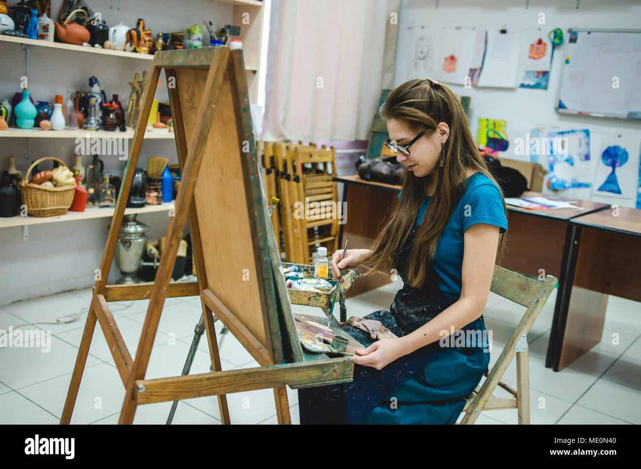 Peintre femelle dessin dans art studio à l'aide d'un chevalet Banque D'Images
