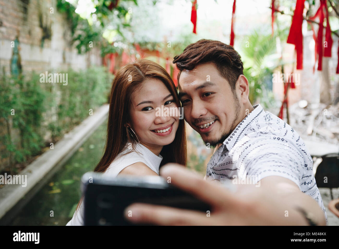 Couple heureux de prendre ensemble selfies Banque D'Images