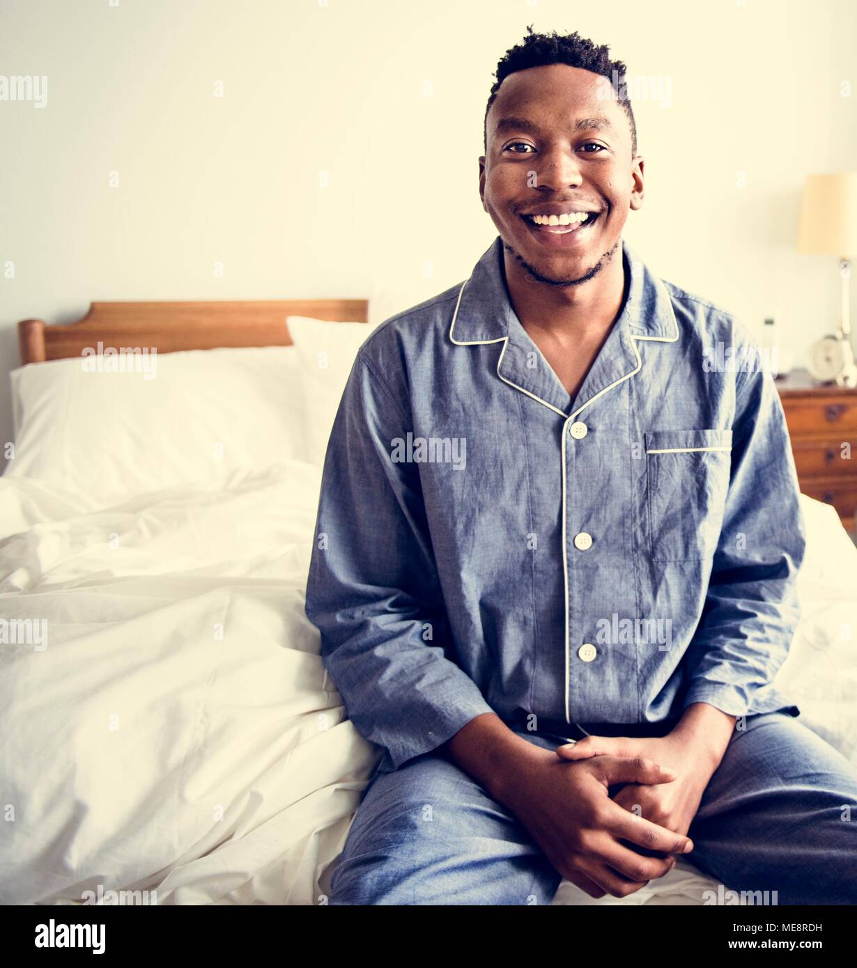 A smiling man in bed Banque D'Images