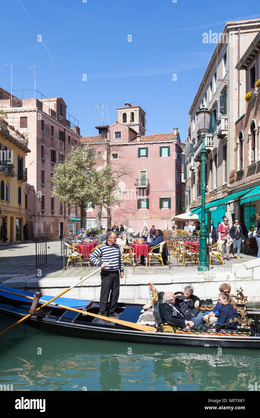 Les touristes en gondole traversant Campo Santa Maria Nova, Cannaregio, Venise, Vénétie, Italie avec des gens assis à des tables de restaurant jouissant de la s Banque D'Images