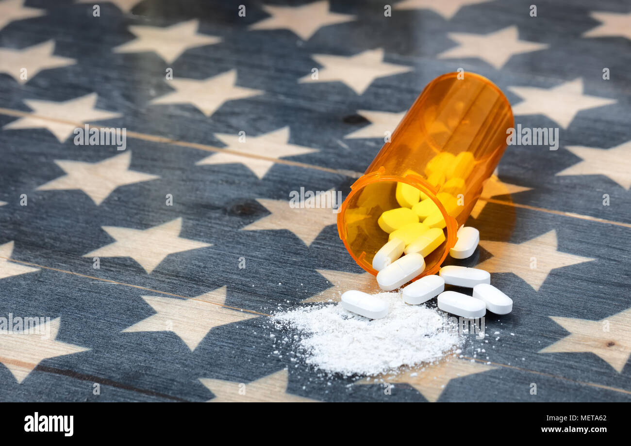Vue avant de bouteille remplie de prescription des opioïdes générique comprimés contre la douleur sur drapeau USA rustique en arrière-plan pour la toxicomanie concept dans Americ Banque D'Images