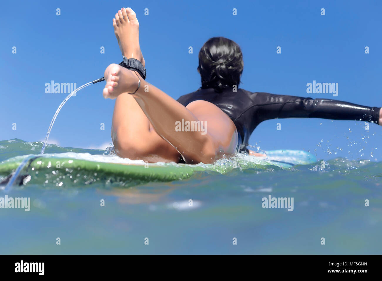 L'INDONÉSIE, Bali, femme surfer allongé sur une planche de surf Banque D'Images