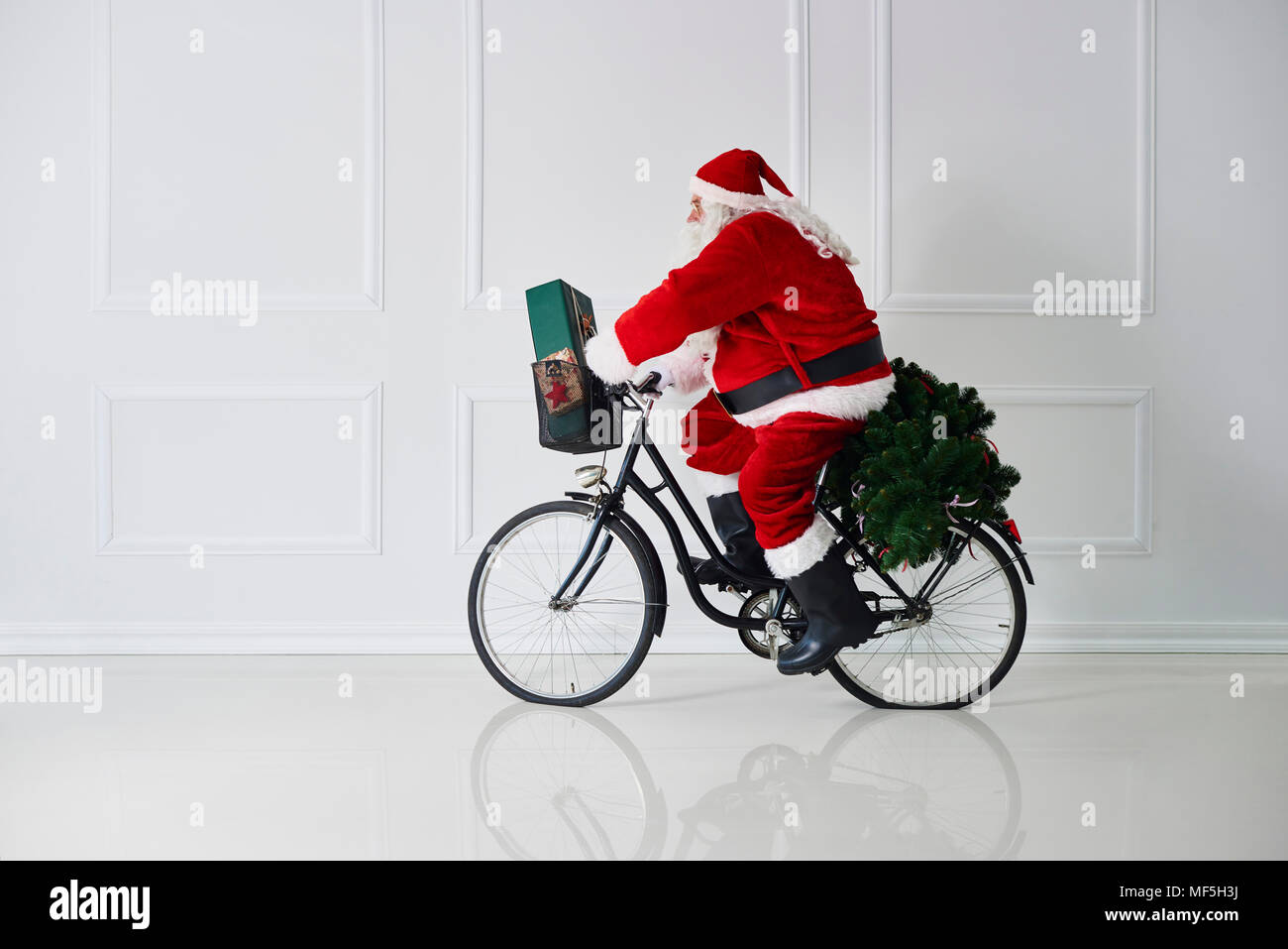 Santa Claus riding bicycle Banque D'Images