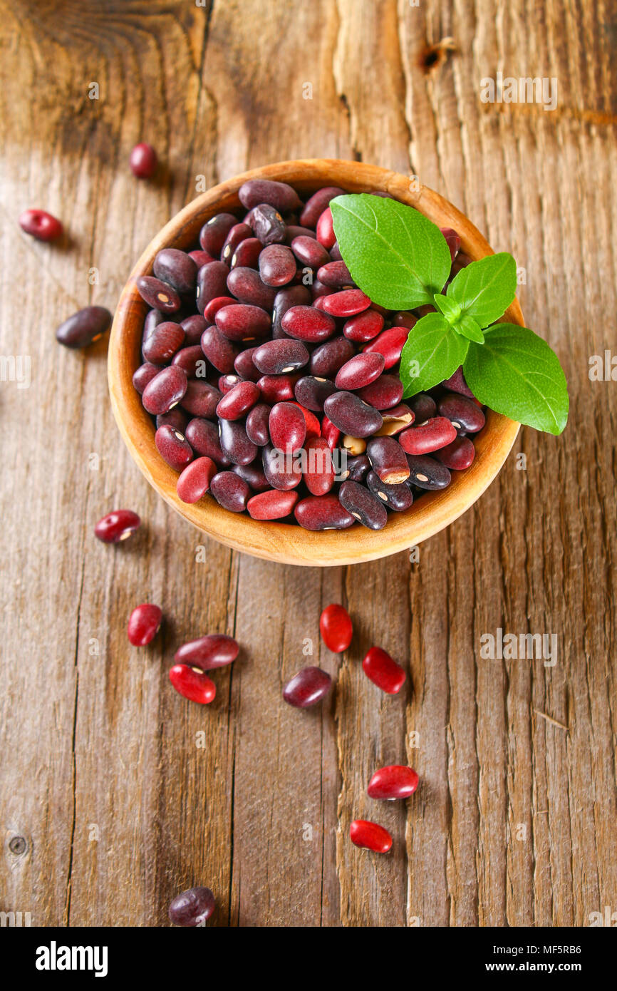 Haricots verts crus rouge avec sur une table en bois Banque D'Images