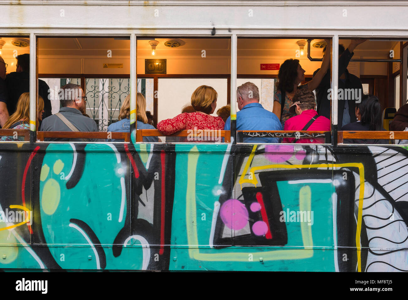 Tram Lisbonne touristes, vue arrière des touristes à l'intérieur d'un tram coloré sur l'Elevador do Gloria dans le quartier de Baixa centre de Lisbonne, Portugal. Banque D'Images