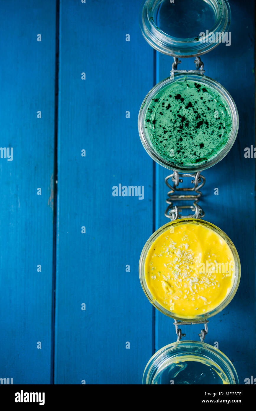 Gateau Au Fromage Sur Un Bocal En Verre Faites A La Mangue Et De La Spiruline En Poudre Avec Des Graines De Chia Et De Noix De Coco En Poudre Sur Un