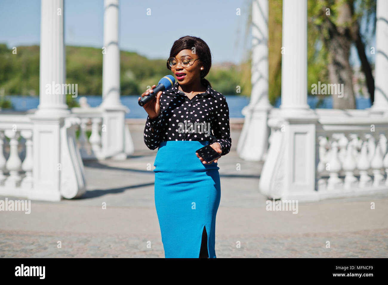 Modèle élégant african american girl présentatrice TV avec microphone