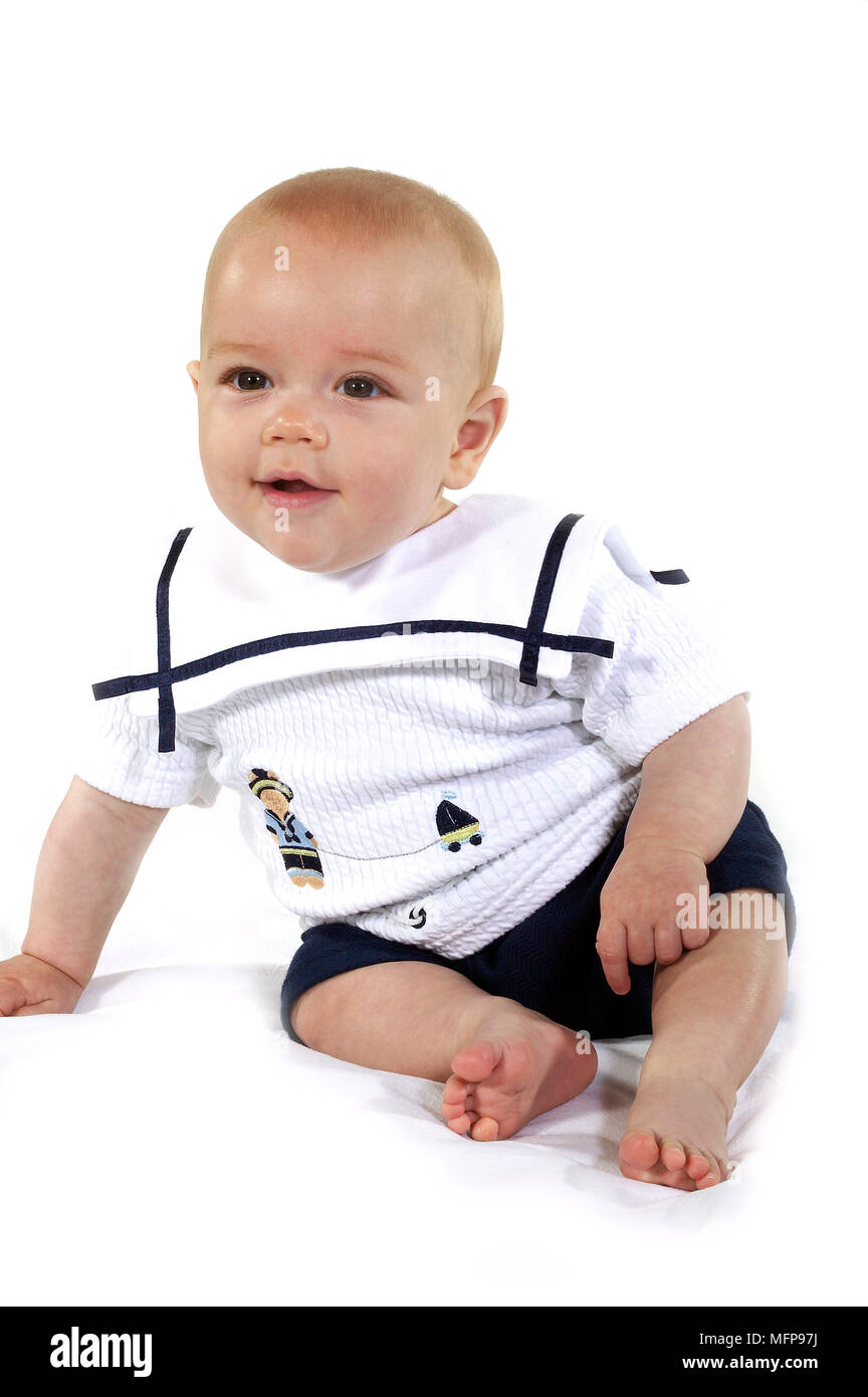 Baby Boy sitting against White Background Banque D'Images