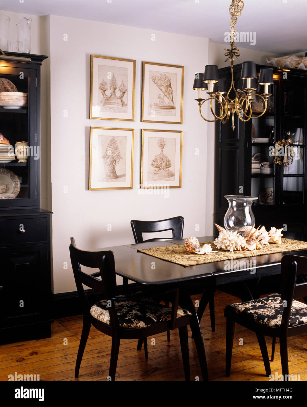 Table de salle à manger et chaises avec armoires et artwork. Banque D'Images