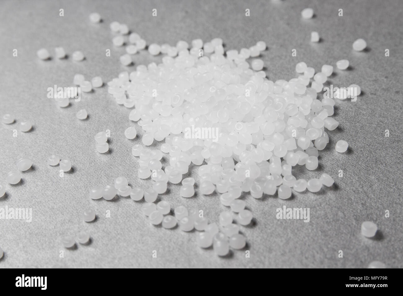 Granulés de polypropylène sur le fond gris. Banque D'Images