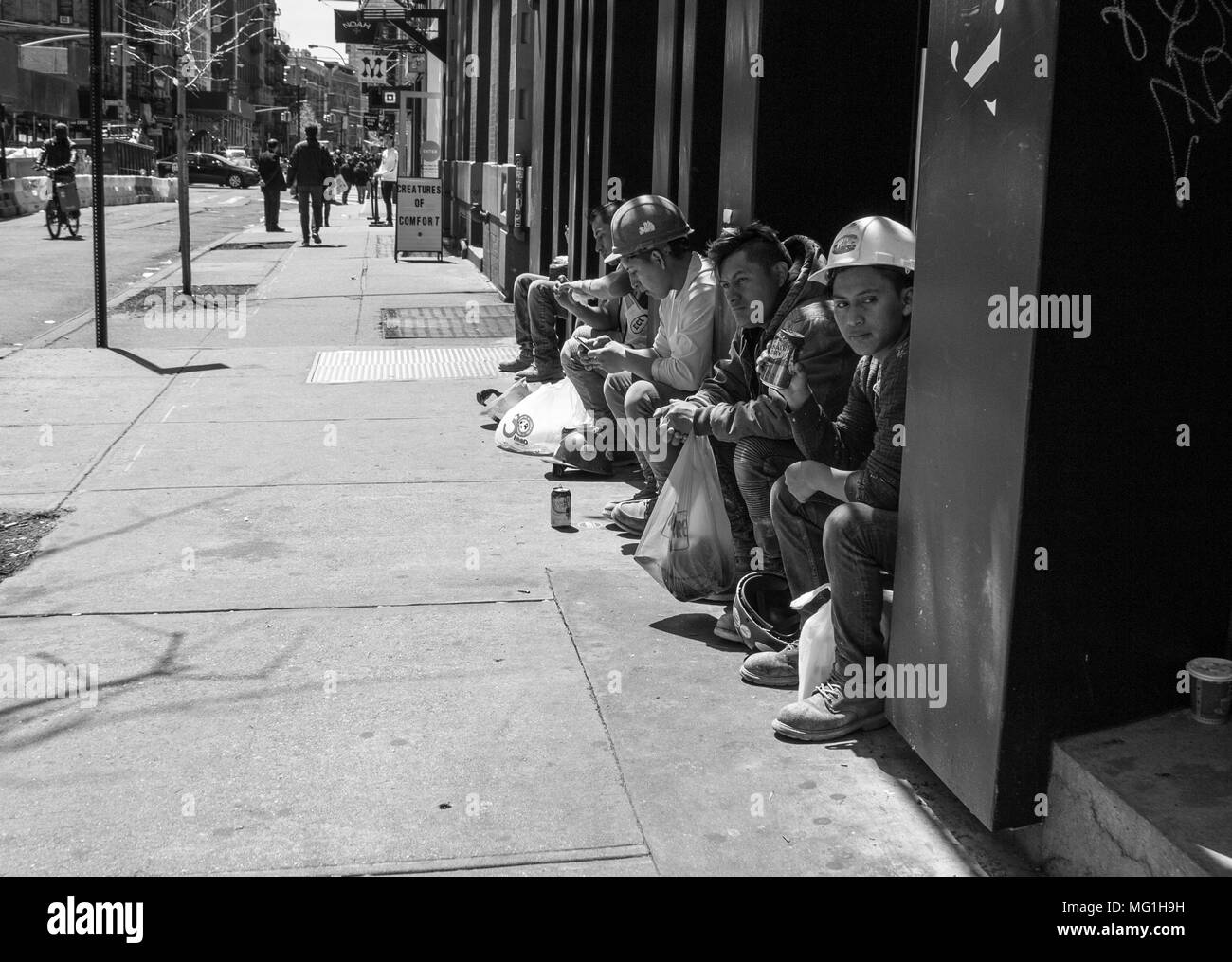 Les travailleurs de la construction en pause hispanique on sidewalk Banque D'Images