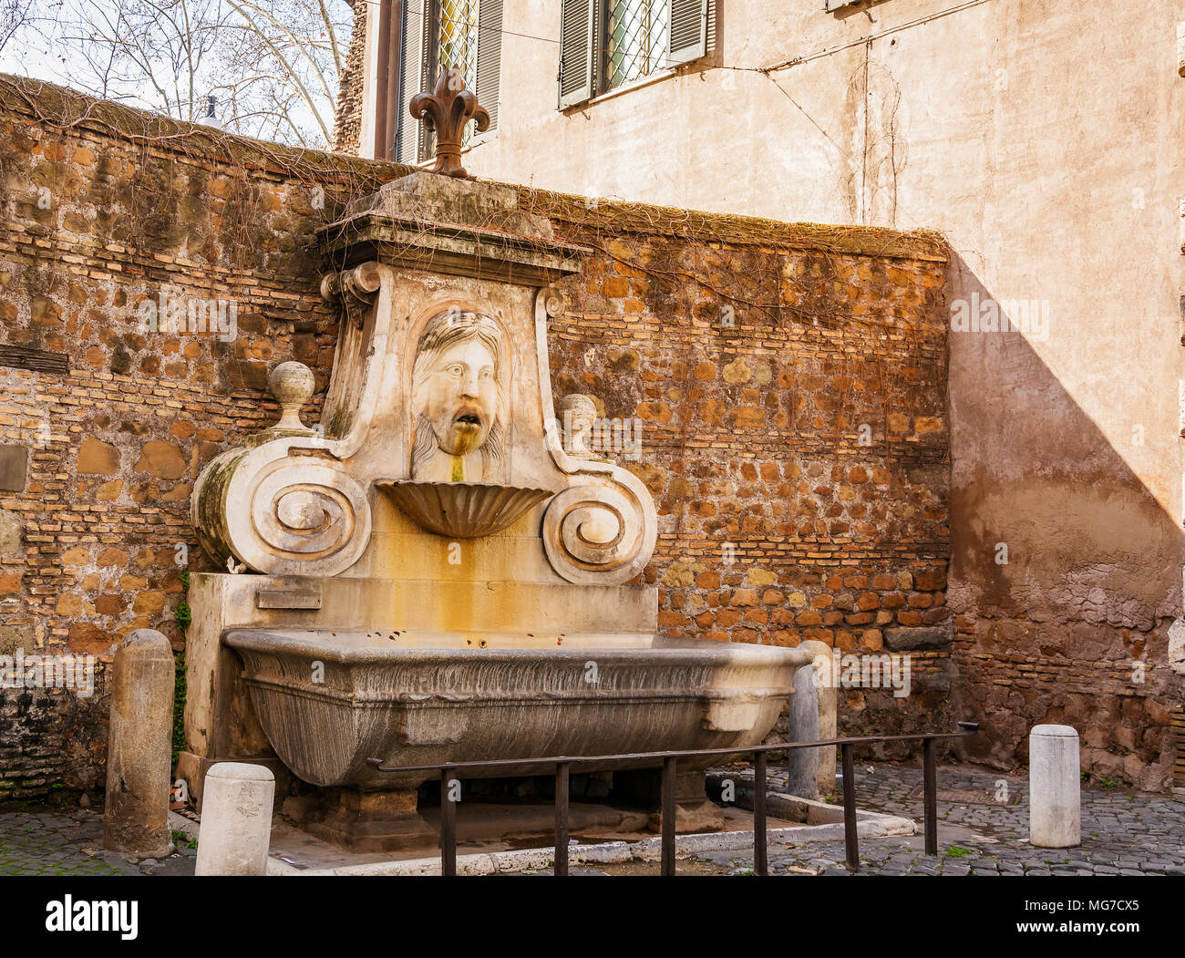 Fontaine dans la Via Giulia, connu sous le nom de mascherone, représentant un visage humain Banque D'Images