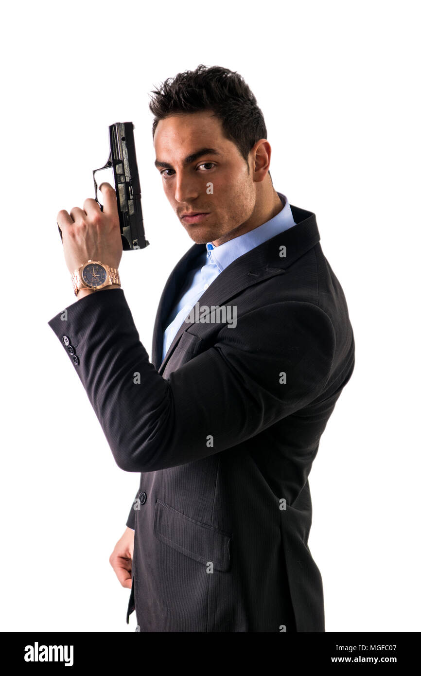 Homme élégant avec arme à feu, habillé comme un espion ou agent secret Banque D'Images