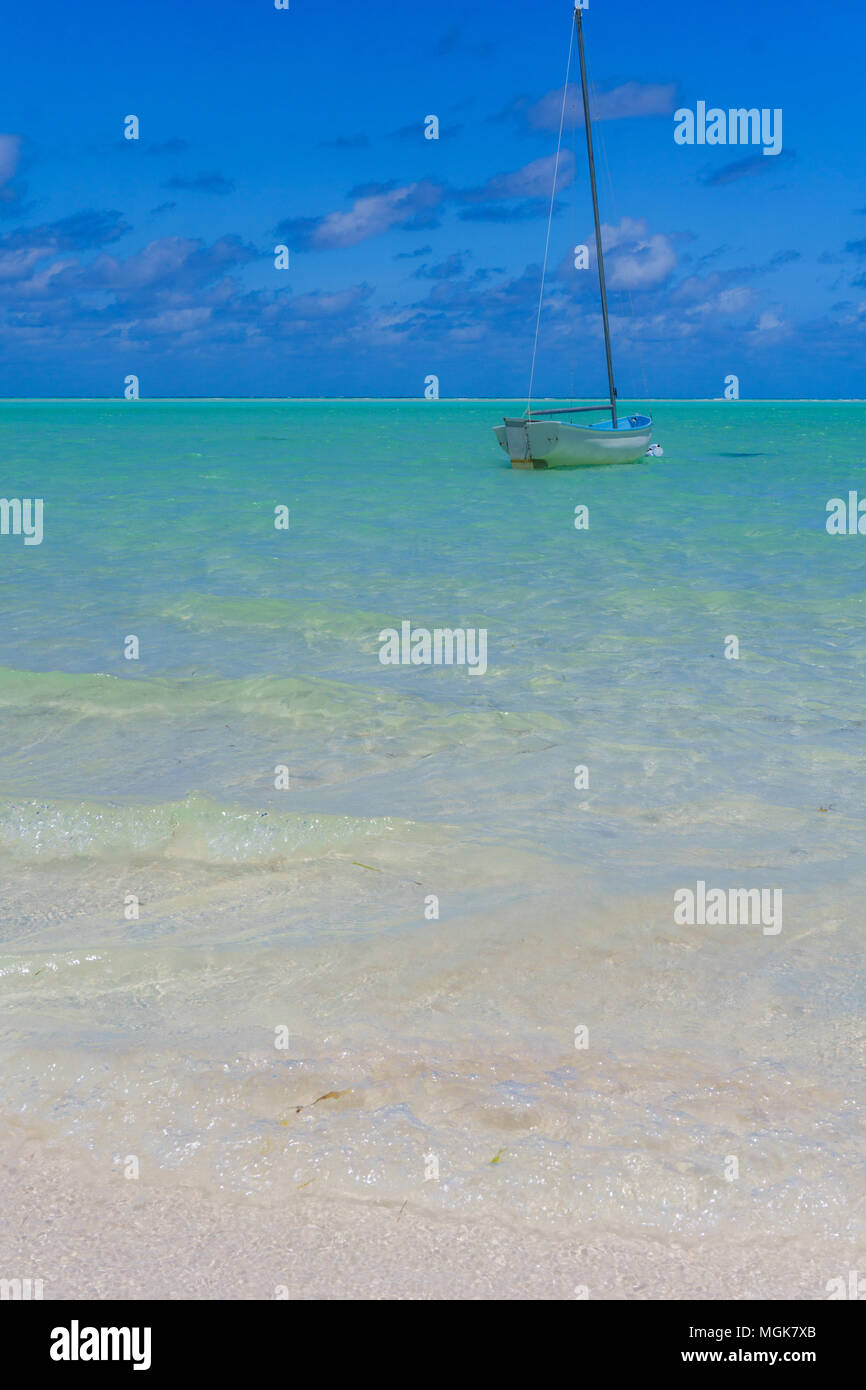 Bahamas - un voilier en bois amarré sur une plage de sable blanc avec de l'eau vert clair, idyllique et ciel bleu Banque D'Images
