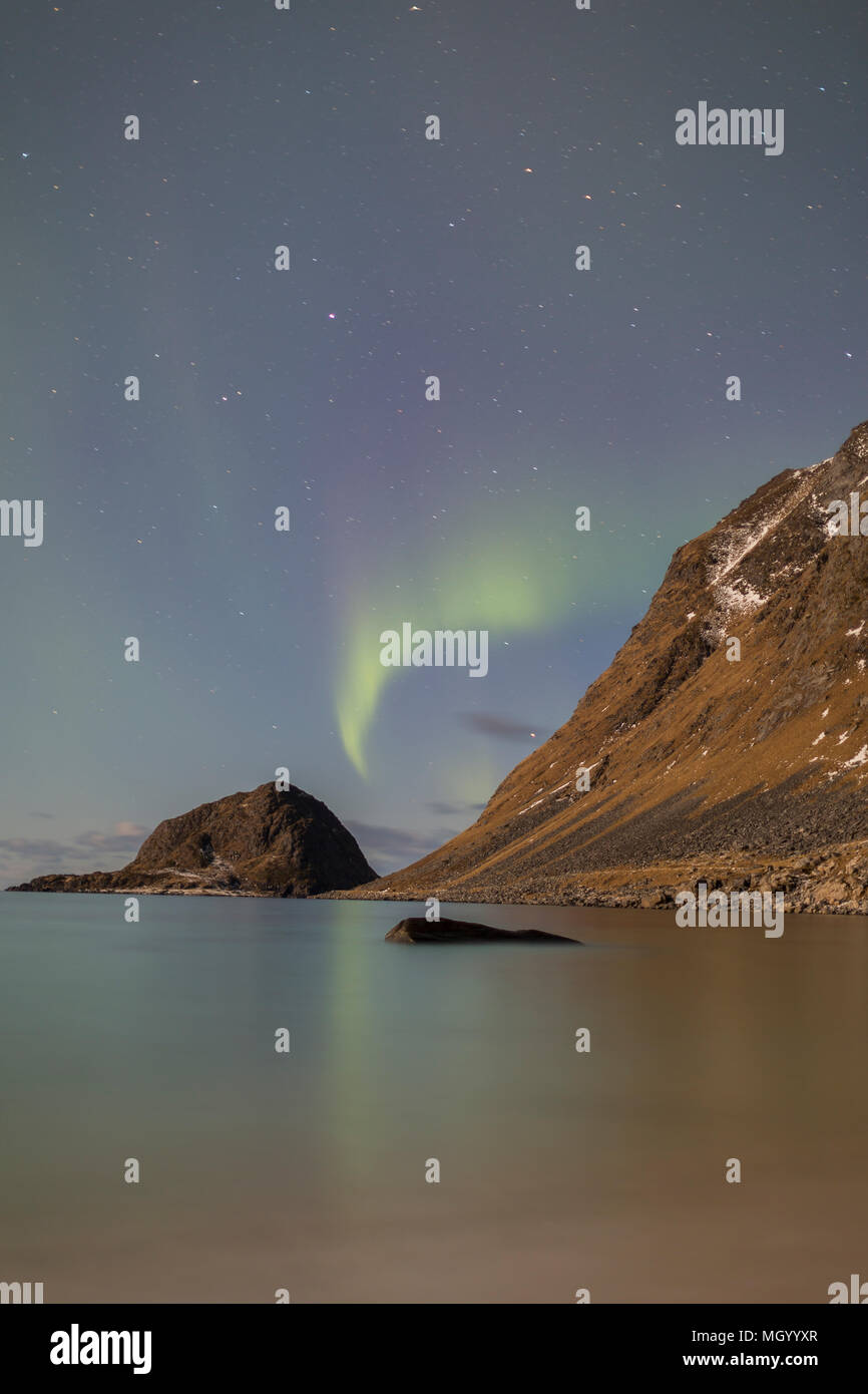 Northern Lights, aurora borealis, reflétée sur la surface de la mer par un beau ciel étoilé à Haukland beach, îles Lofoten, Nordland, Norvège Banque D'Images
