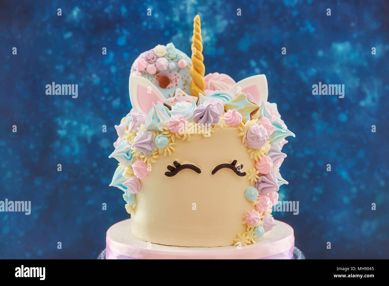 Gros gâteau coloré en forme de visage unicorn Banque D'Images