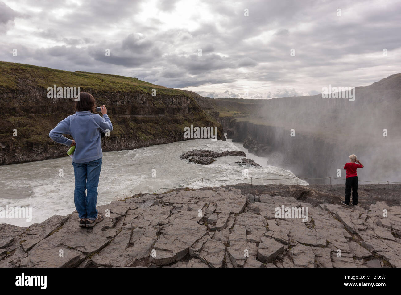 Prendre des photos de tourisme dans la limite de la chute de Gullfoss, cascade situé dans le canyon de la rivière Hvítá dans le sud-ouest de l'Islande. Banque D'Images