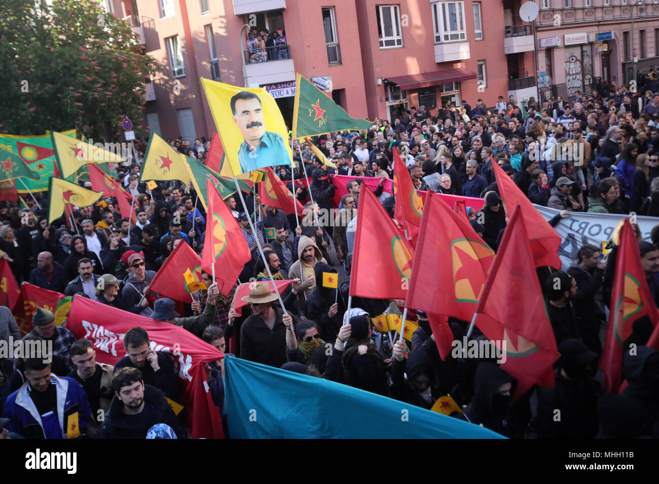 01 mai 2018, l'Allemagne, Berlin : Les participants à la manifestation du 1er mai révolutionnaire holding drapeaux du Parti des Travailleurs du Kurdistan (PKK), avec le président du PKK Abdullah Ocalan et de la protection de l'environnement Unités (GPJ). Photo : Michael Kappeler/dpa Banque D'Images