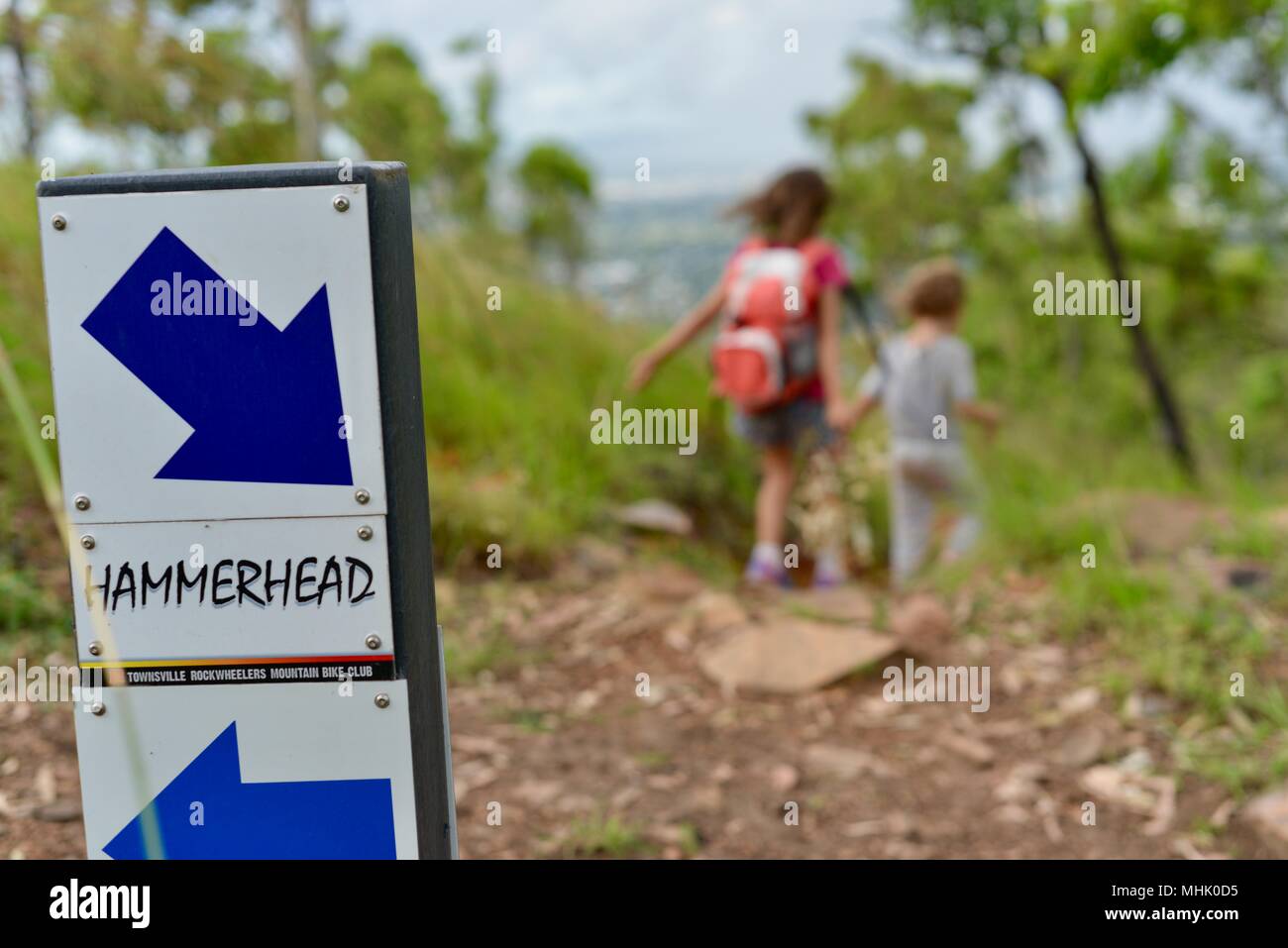 Deux enfants à pied le long d'un chemin à travers une forêt, Mount Stuart des sentiers de randonnée, Townsville, Queensland, Australie Banque D'Images